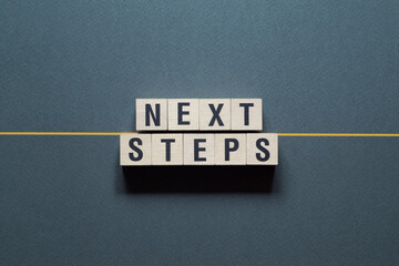 Wall Mural - Next steps - word concept on cubes,text