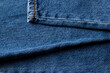 Blue jeans texture with a orange stich. Abstract denim cotton fabric