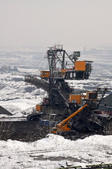 A huge excavator on a surface coal mine in winter conditions. Interesting appearance of surface mining under snow.