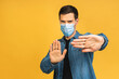 Protection against contagious disease, coronavirus, covid-19. Man wearing hygienic mask to prevent infection, airborne respiratory illness such as flu, 2019-nCoV. Isolated over yellow background