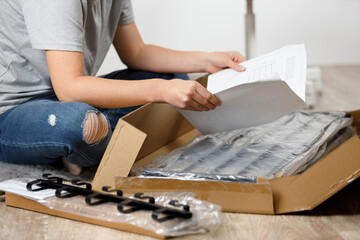 Difficulties in assembling new furniture, opening a box in a home interior.