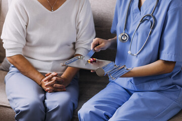 Homecare nursing service and elderly people cardiology healthcare. Close up of young hispanic female doctor nurse check mature caucasian man patient heartbeat using stethoscope during visit