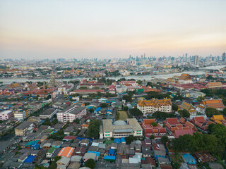 Wall Mural - Aerial view Bangkok city buddhist temple with river sunset sky