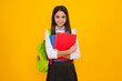 School teenager child girl 12, 13, 14 years old with school bag book and copybook. Teenager schoolgirl student, isolated background. Learning and knowledge.