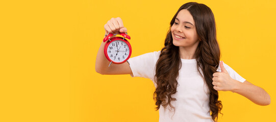 Canvas Print - happy child hold retro alarm clock showing time, thumb up. Teenager child with clock alarm, horizontal poster. Banner header, copy space.