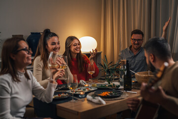 Wall Mural - Happy friends celebrating on a dinner party