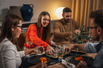 Wall Mural - Happy friends are enjoying a nice dinner