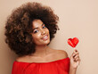 canvas print picture - Beautiful portrait of an African girl with a heart shaped lollipop. Valentine's Day. Symbol of love