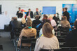 © tsuguliev - Audience at the conference hall listens to lecturer, people on a congress together listen to speaker on a stage at master-class, corporate business seminar