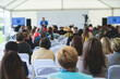 © tsuguliev - Audience at the conference hall listens to lecturer, people on a congress together listen to speaker on a stage at master-class, corporate business seminar