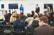 © tsuguliev - Audience at the conference hall listens to lecturer, people on a congress together listen to speaker on a stage at master-class, corporate business seminar