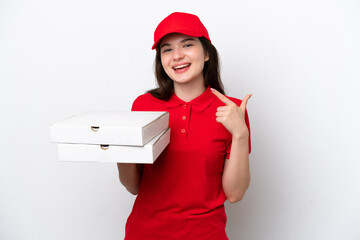 Wall Mural - Young Russian pizza delivery picking up pizza boxes isolated on white background giving a thumbs up gesture