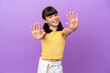 Little caucasian kid isolated on purple background counting ten with fingers