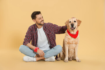 Sticker - Happy man with his cute Labrador Retriever on beige background