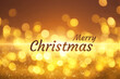 © New Africa - Greeting card with phrase Merry Christmas on golden background with blurred lights