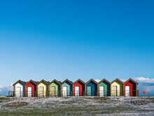 Colorful Beach Huts With Blue Sky Background And Frost