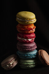 Wall Mural - colorful macaroons on black background 