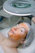 © Anna - Cosmetologist and dermatologist makes a moisturizing, rejuvenating woman lying patient in a beauty salon.