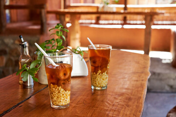 Mote con huesillo in a glass on the wooden table in a small restaurant in Valle del Elqui 