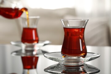 Wall Mural - Glass of traditional Turkish tea on table indoors, space for text