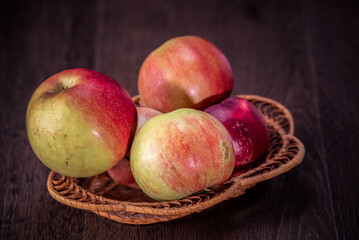 Wall Mural - Still life of fresh peaches and apples on a dark background.