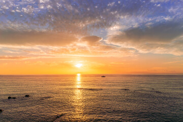 view at sunrise or sunset in sea with nice beach , surf , calm water and beautiful clouds on a background of a sea landscape