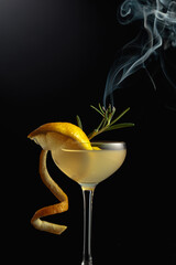 Limoncello garnished with a steaming rosemary branch.