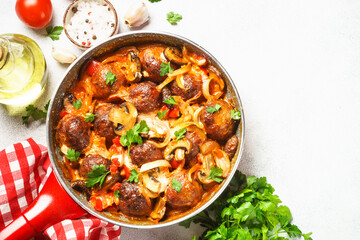 Sticker - Meatballs with mushrooms in tomato sauce in a frying pan.