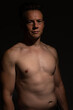 © Collins Photography - Sexy portrait of muscular handsome topless male isolated against a black background