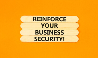 Wall Mural - Reinforce your business security symbol. Concept word Reinforce your business security on sticks. Beautiful orange background. Business reinforce your business security concept. Copy space.