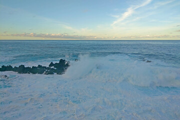 Wall Mural - Beautiful view of the waves of the Atlantic Ocean, which crash against the rocks.