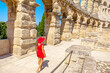 Tourist girl walking inside Pula Amphitheater or Coliseum of Pula is a well-preserved Roman amphitheater, in Pula, Istria of Croatia.Ancient Roman empire arena in Pula constructed in 27 BC-68 AD
