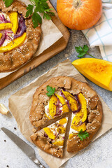 Canvas Print - Homemade pumpkin Galette. Healthy homemade wholegrain vegan vegetarian pie (galette) with pumpkin and ricotta cheese on a stone table. View from above.