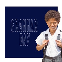 Sticker - Portrait of african american school boy smiling against grammar day text banner on blue background