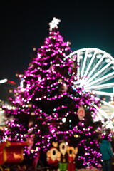 Wall Mural - Christmas tree with defocused lights. Dark background