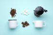Flat lay composition with roasted beans and geyser coffee maker on light blue background