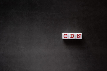 Poster - There is white cube with the word CDN. It is an abbreviation for Content Delivery Network as eye-catching image.