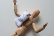 wooden doll with unicorn finger puppet