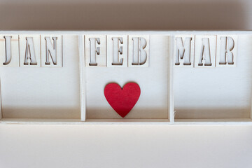 Poster - jan, feb, mar with red heart inside a wooden box