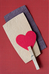 Wall Mural - isolated felt heart with clothespin on rough and corrugated paper