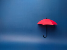  A Red Umbrella On A Blue Background With Copy Space., Planning, Saving Families, Preventing Risks And Crises, Health Care And Insurance Concepts.