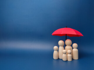 a family of wooden dolls are hiding under a red umbrella, protecting wooden peg dolls, planning, sav
