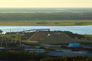 Wall Mural - Aerial view of wood processing factory with smoke from production process polluting atmosphere at plant manufacturing yard. Industrial site at sunset