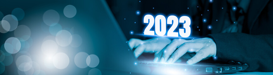 Wall Mural - businessman using laptop computer search 2023 trends,happy new year concept digital trends,industry 
