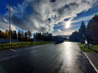 Sun reflections on wet asphalt of resting place in Sweden