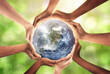 © Puttachat - Conceptual symbol of multiracial human hands surrounding the Earth globe. Unity, world peace, humanity concept. World environment day- Earth Day concept. Elements of this image furnished by NASA.