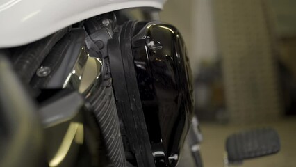 Poster - A mechanic screwing on the air filter cap after changing the filter on a motorcycle. Close-up. Transport.