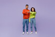 © ViDi Studio - Full body young happy couple two friends family man woman of African American ethnicity wearing casual clothes together meet each other give fist bump isolated on pastel plain light purple background.