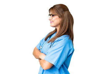 Wall Mural - Middle age nurse woman over isolated background in lateral position