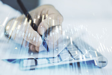 Double exposure of abstract creative financial chart with hand writing in notebook on background, research and strategy concept